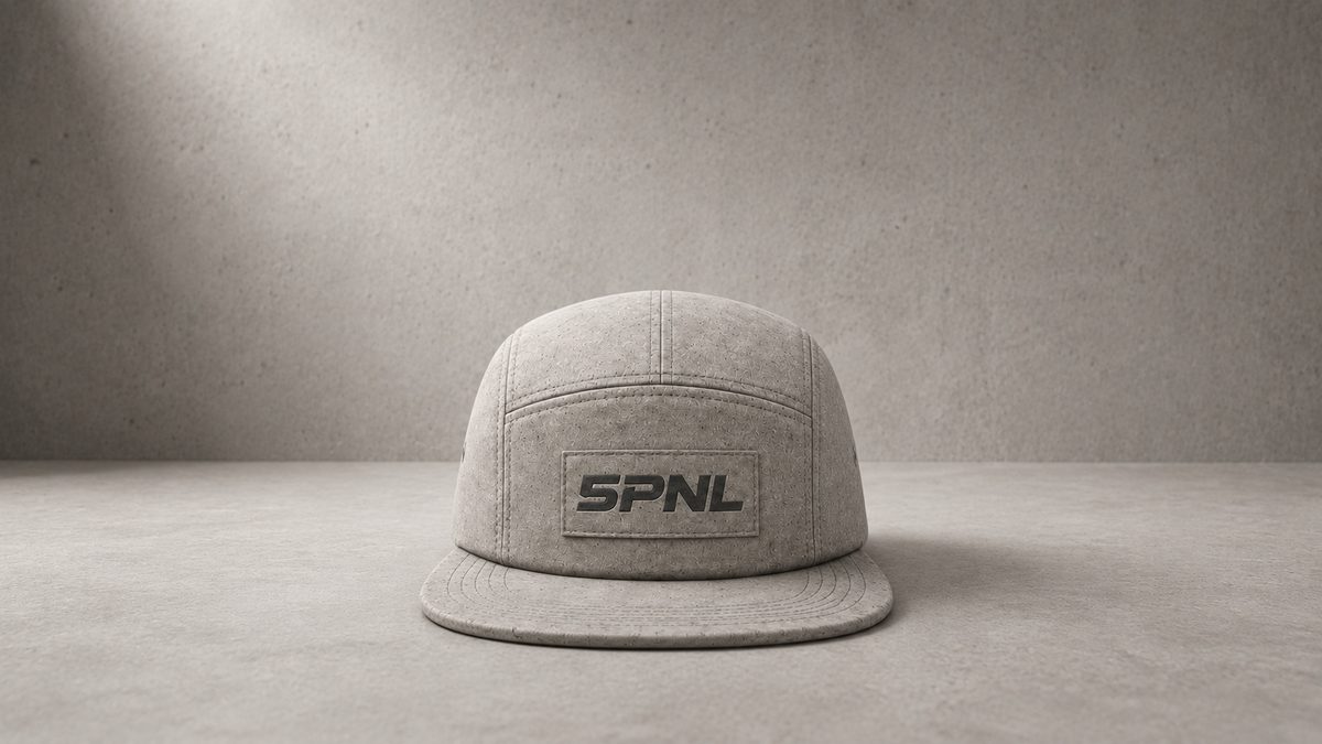 Centered gray 5PNL cap facing the camera on a concrete floor